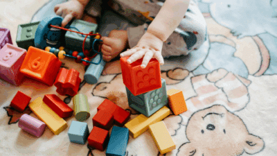 Photo of toddler playing with colorful blocks.