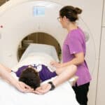 CT Scan Caregiver providing a CT to a patient