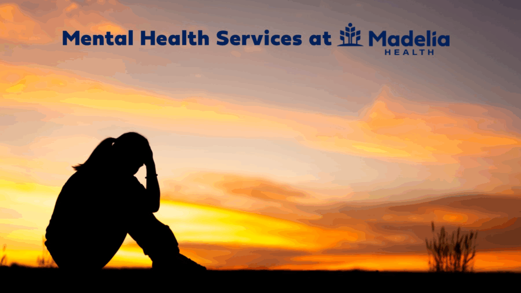 Picture of person sitting in front of a sunset with their head in their hands. Text reads, "Mental Health Services at Madelia Health".